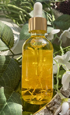 Sage & Stone Apothecary calendula body oil bottle with dropper, showcasing natural calendula extract for skin care.