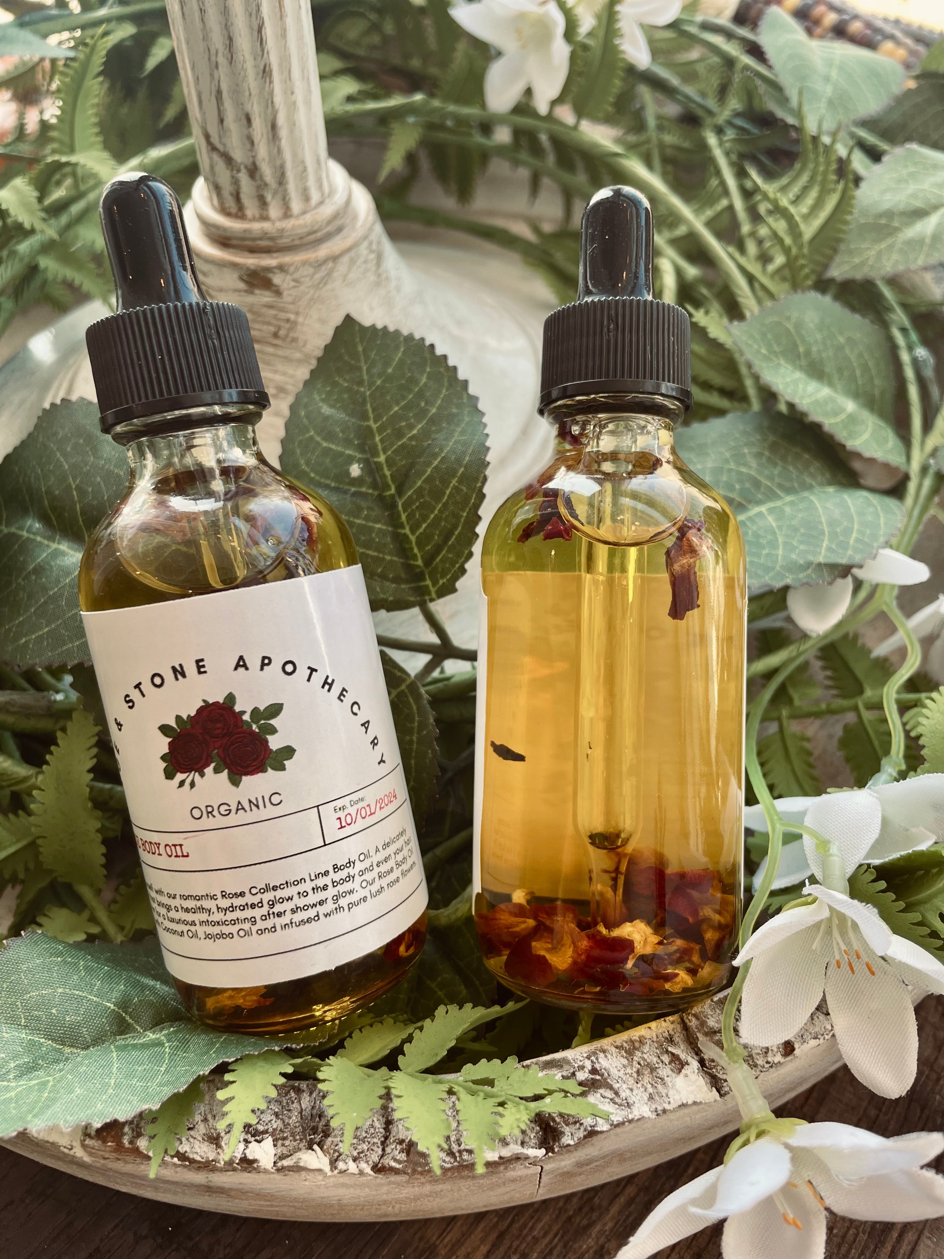 Sage & Stone Apothecary rose body oil bottle with a dropper, showing the luxurious pink-hued oil in a clear glass container.