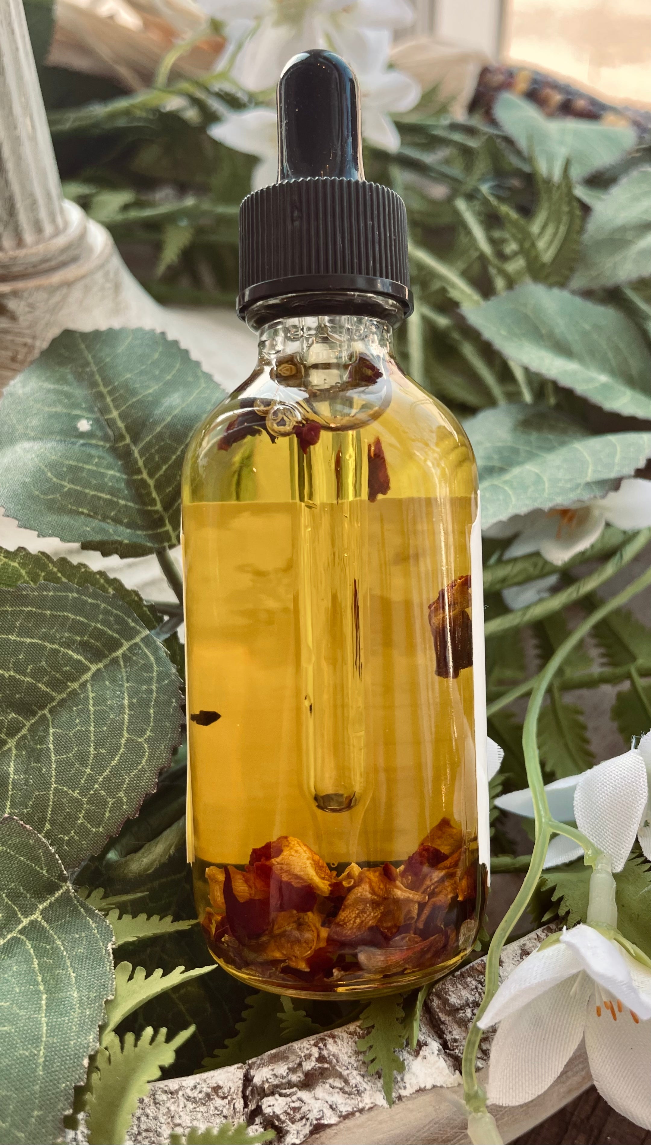 Sage & Stone Apothecary rose body oil bottle with a floral design, showcasing natural ingredients and elegant packaging.