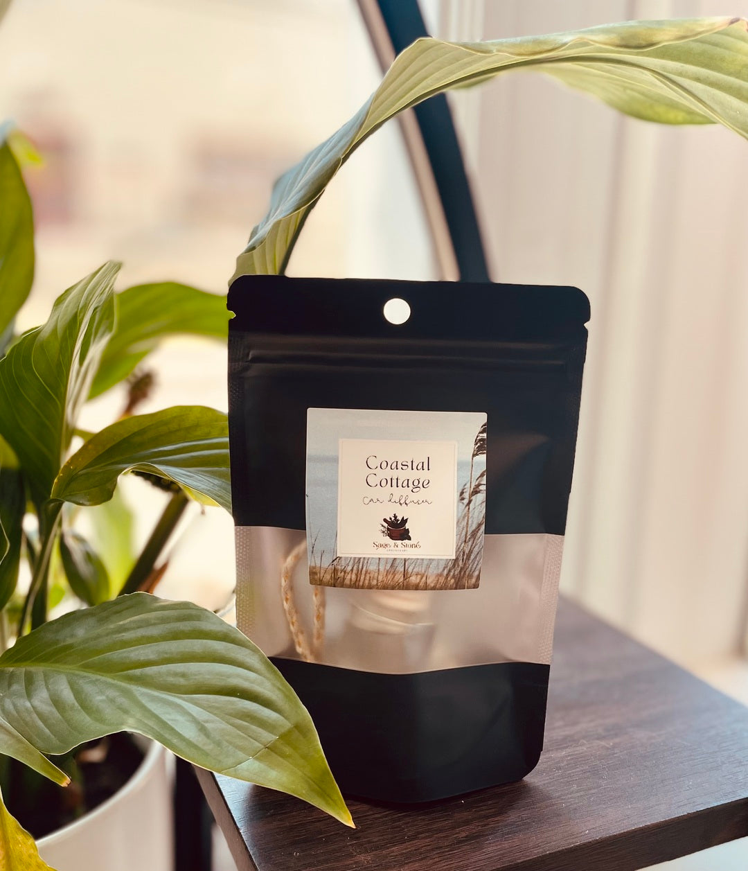 Sage & Stone Apothecary Coastal Cottage car diffuser with a sleek design and natural wooden accents, perfect for calming vehicle scents.