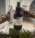Sage & Stone Apothecary enchanted room spray bottle with floral and herbal labels, ready for home fragrance use.
