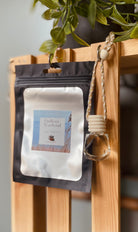 Endless Weekend car diffuser by Sage & Stone Apothecary with wooden cap and white ceramic body, designed for aromatic car freshening.