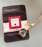 Pink Sugar Car Diffuser by Sage & Stone Apothecary with pink decorative accents and a sleek design for adding fragrance to your vehicle.