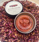 Rose clay lotion bar by Sage & Stone Apothecary shown in a natural setting with a smooth, rounded shape and a soft pink hue.