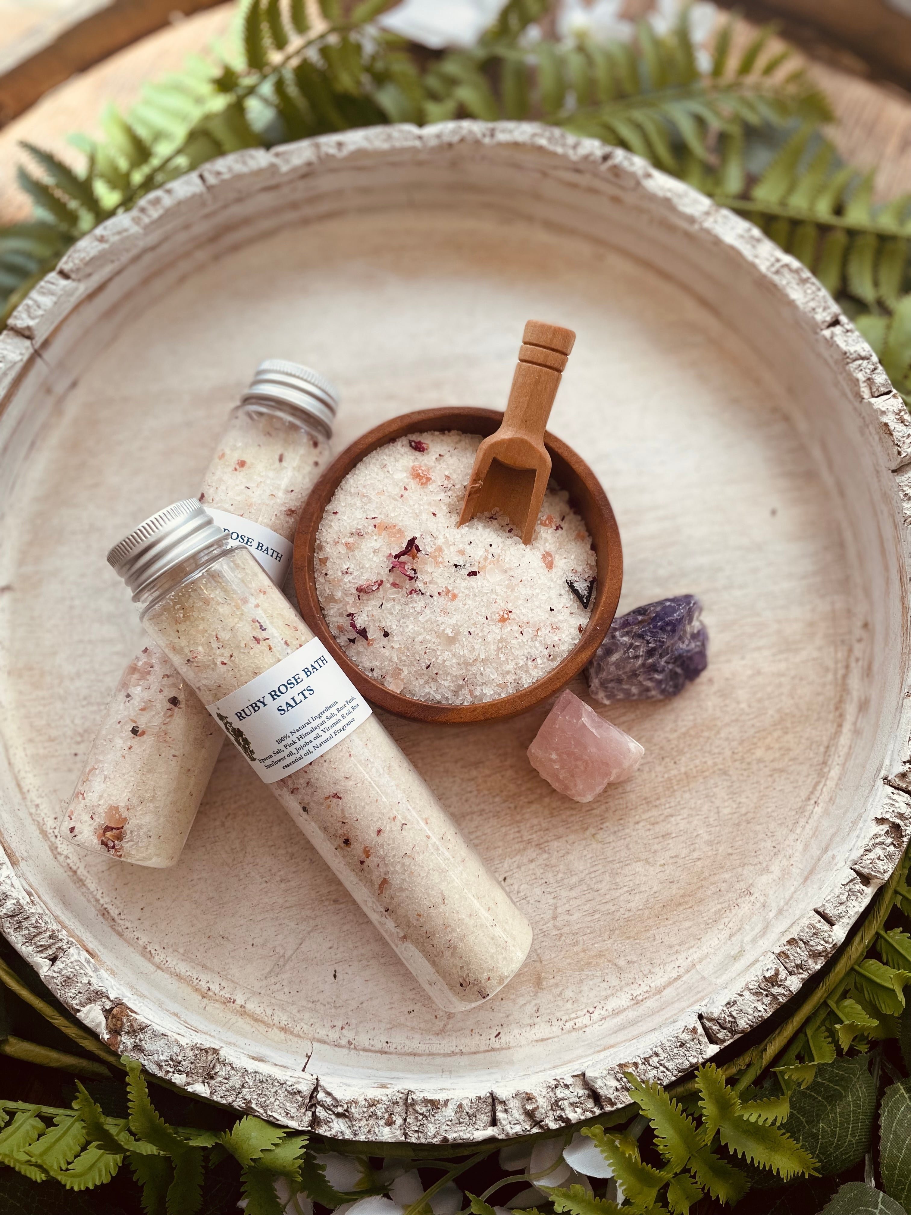 Sage & Stone Apothecary Ruby Rose bath salt tubes with pink and white floral packaging on a white background.