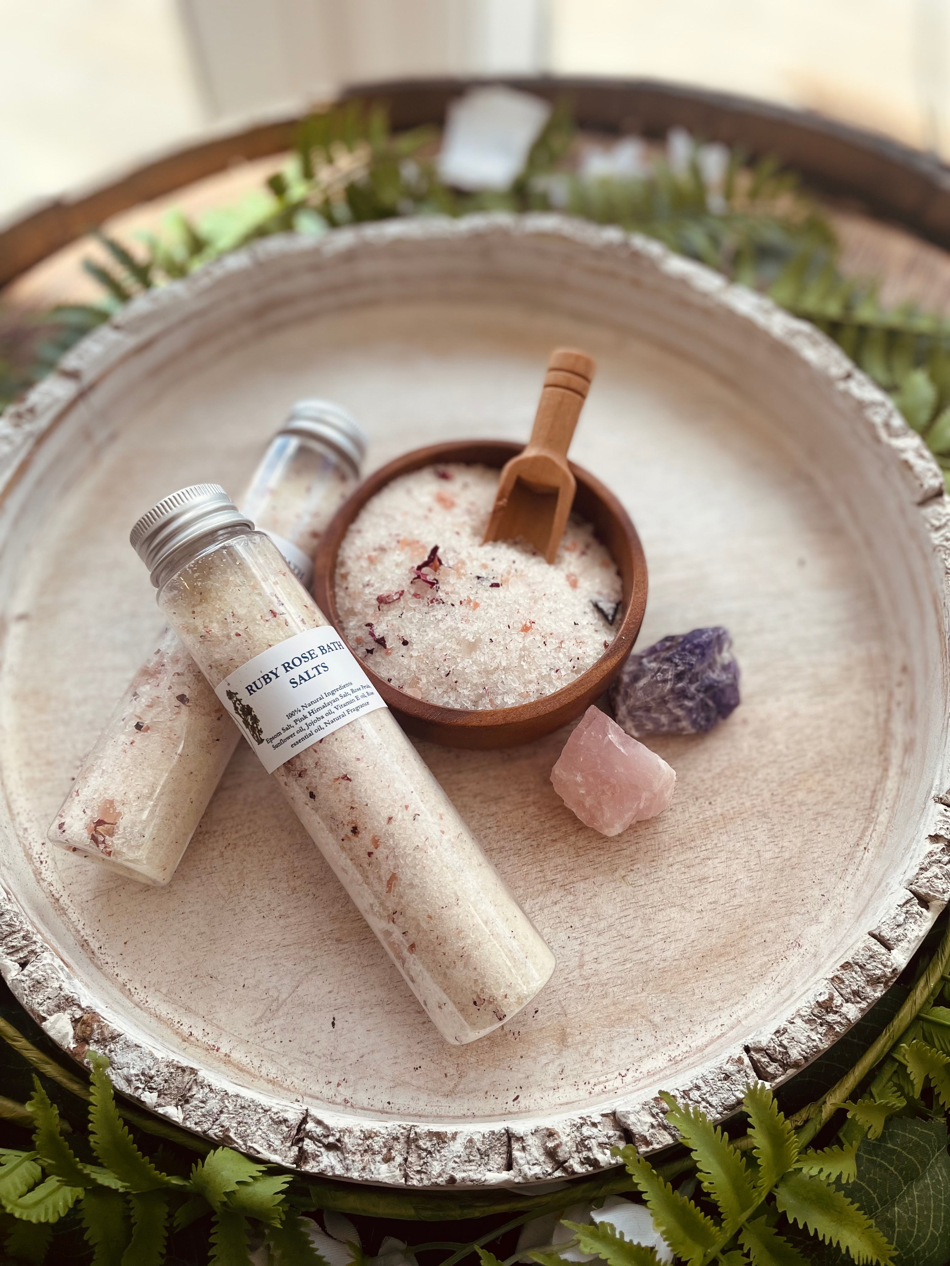 Set of Sage & Stone Apothecary Ruby Rose bath salt tubes with floral packaging and elegant labels on a neutral background.