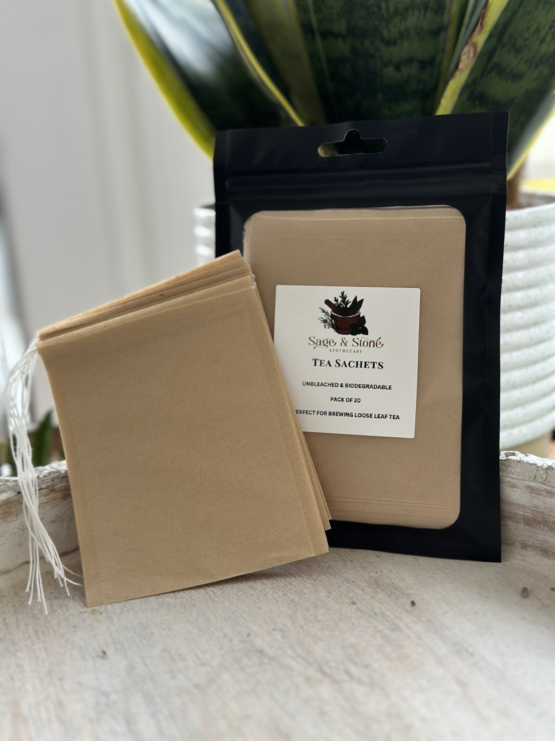 Biodegradable loose leaf tea bag sachet from Sage & Stone Apothecary, showing eco-friendly packaging and tea leaves inside.