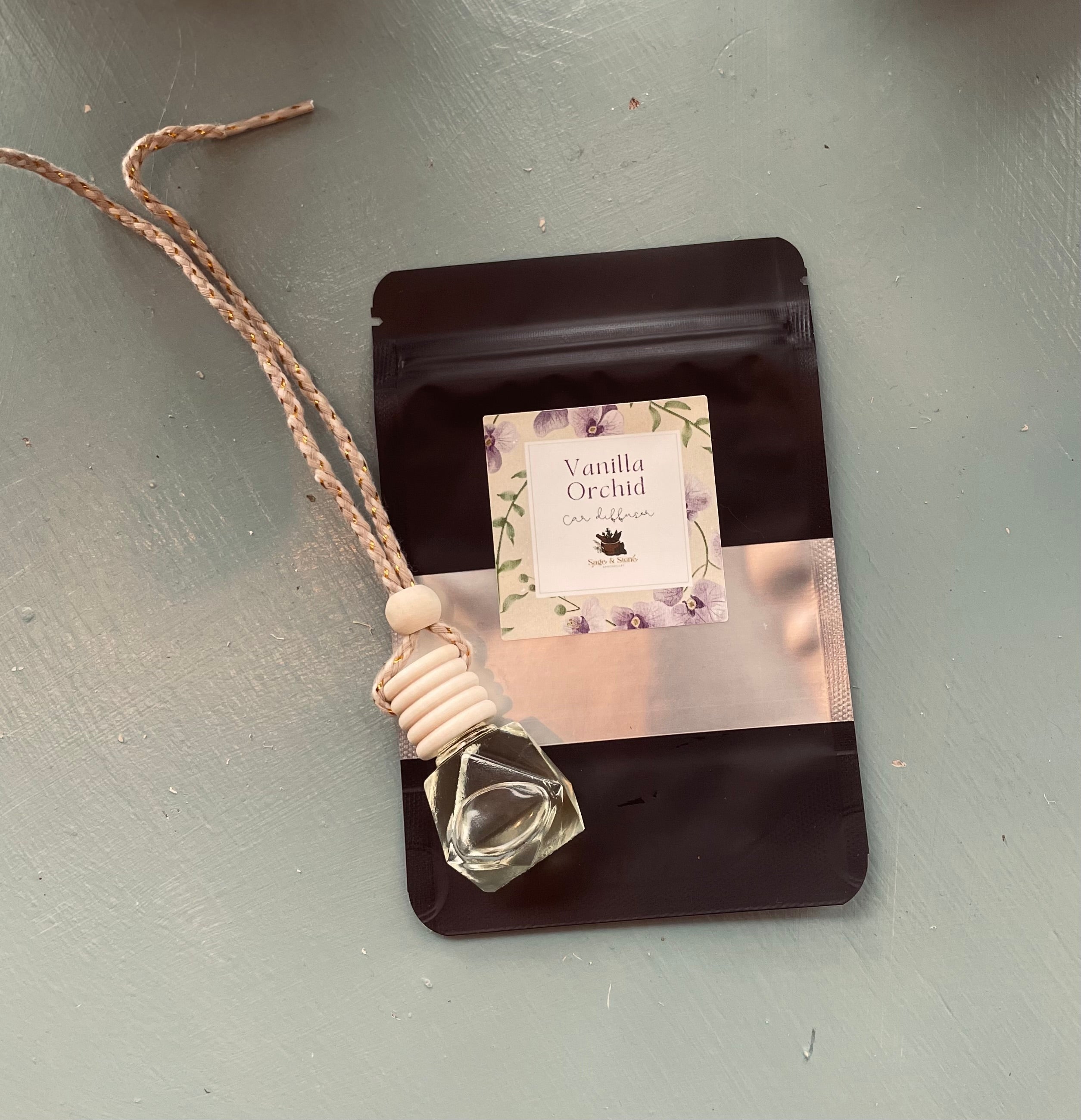 Vanilla Orchid car diffuser by Sage & Stone Apothecary, showcasing the elegant diffuser with vanilla orchid scent in a sleek design.