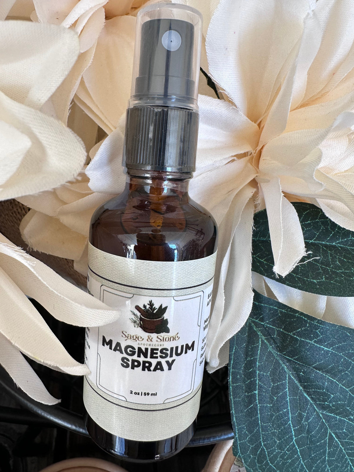Sage & Stone Apothecary magnesium oil spray bottle showing the product label and spray nozzle.