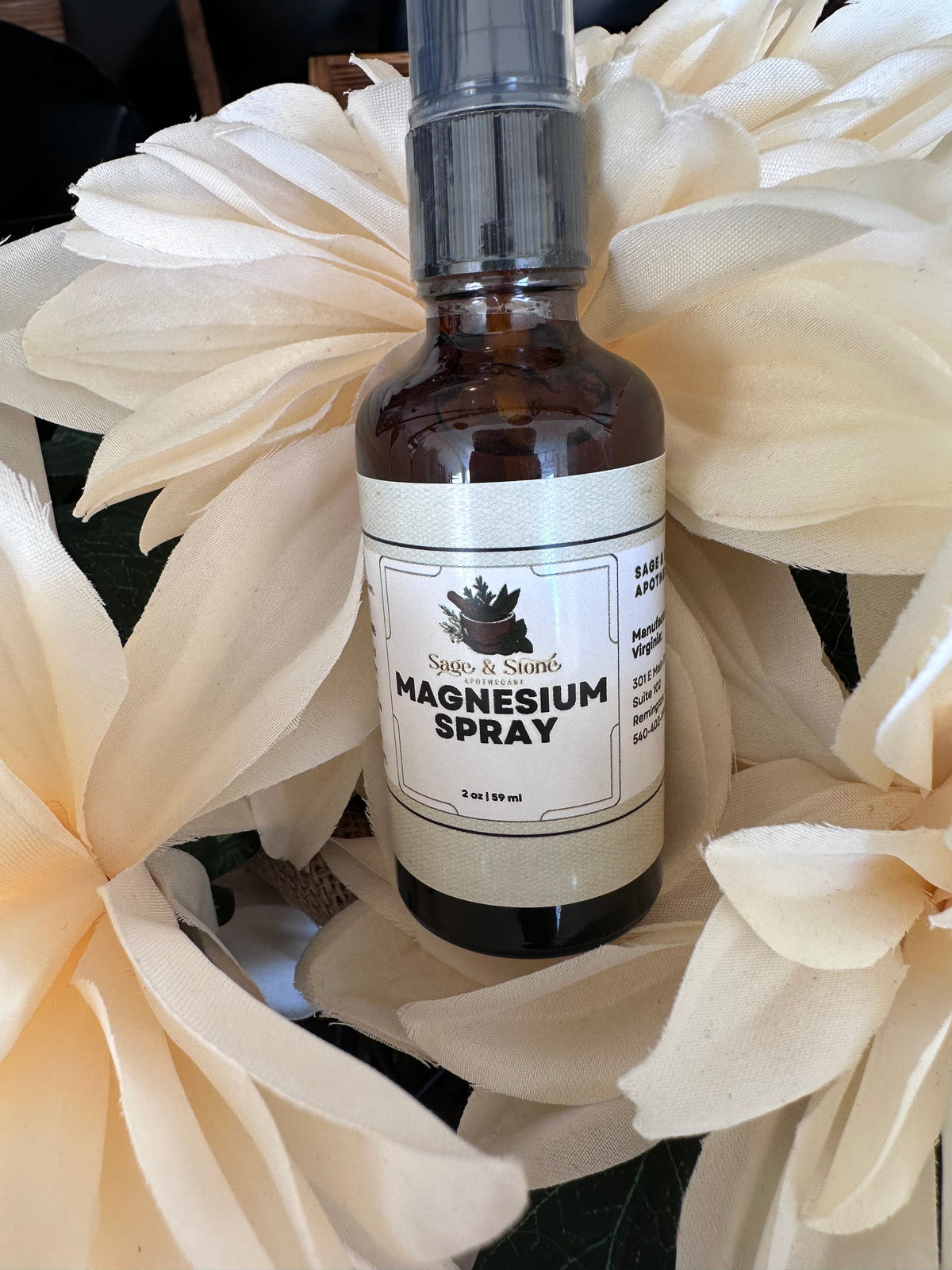 Spray bottle of Sage & Stone Magnesium Oil Spray with a clear label, designed for topical magnesium application.