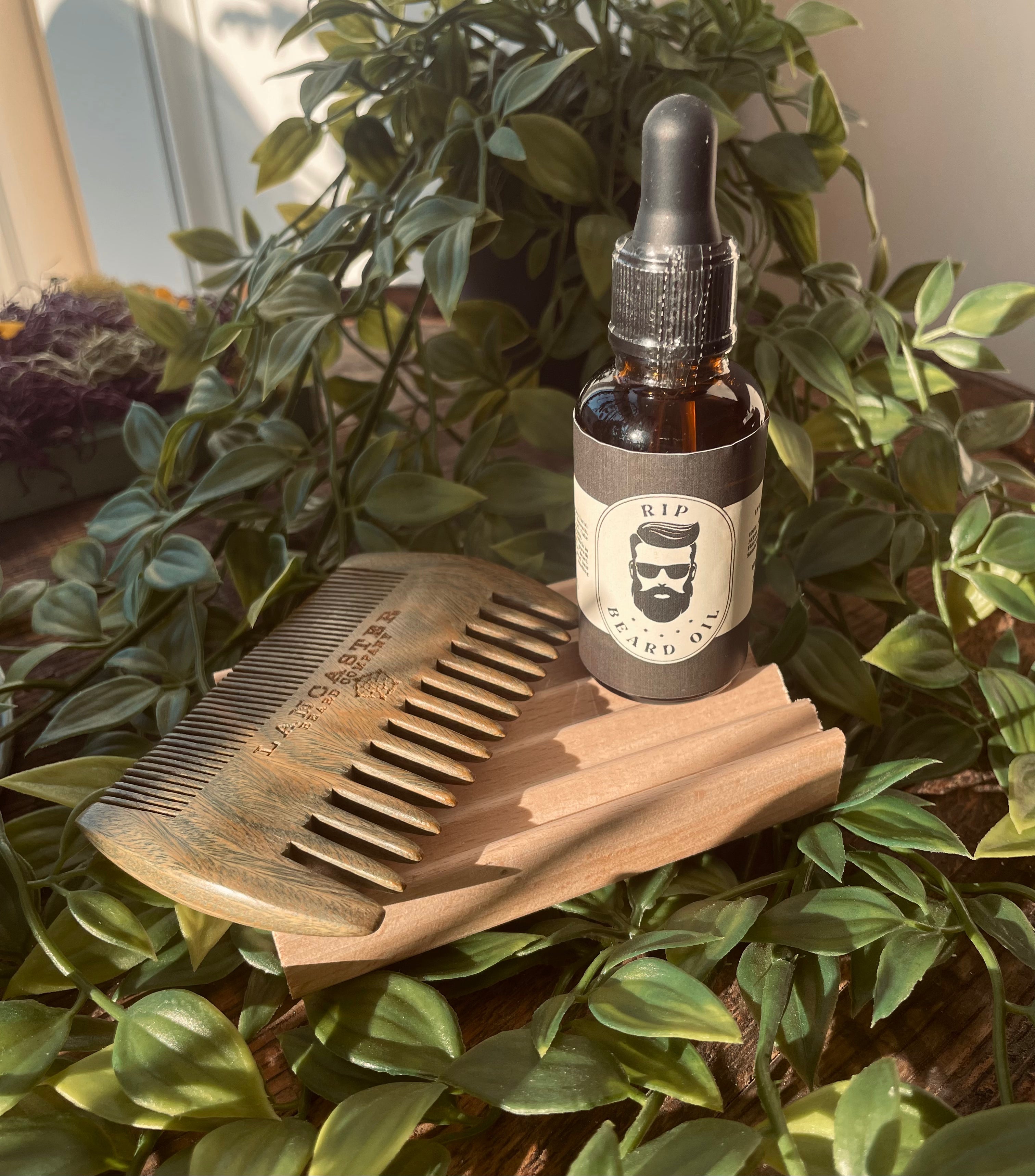 Men's RIP Beard Oil by Sage & Stone Apothecary, close-up of the dark glass bottle with dropper cap and label.