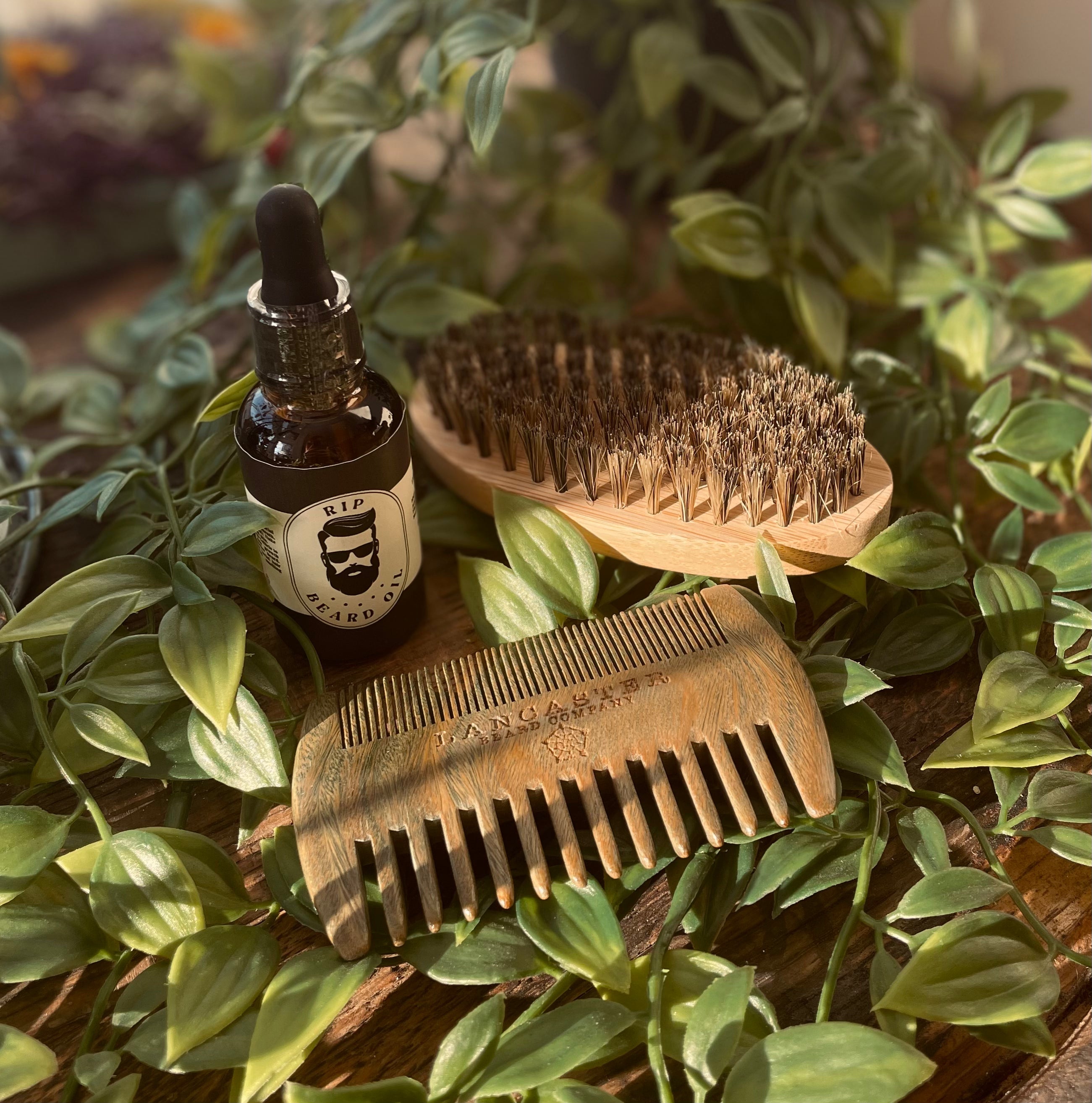 Men's RIP Beard Oil by Sage & Stone Apothecary, close-up of the dark glass bottle with dropper for grooming and beard care.