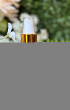 Sage & Stone Apothecary facial toner in a glass bottle with a spray nozzle, surrounded by natural botanical ingredients.