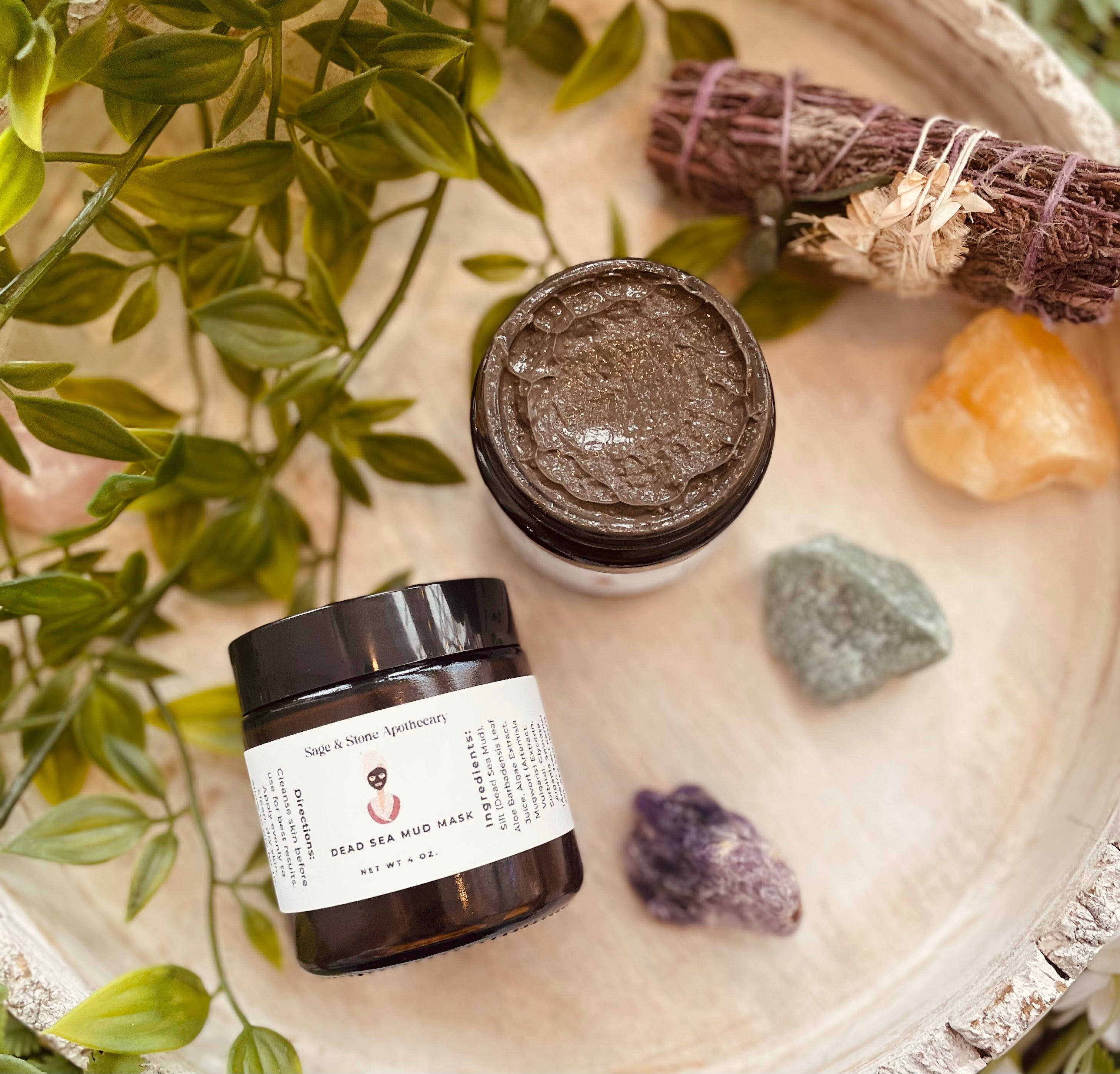Sage & Stone Dead Sea Black Mud Mask in a jar, used for facial skincare, with black mud and natural ingredients visible.