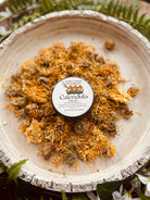 Calendula salve jar from Sage & Stone Apothecary, natural personal care balm with herbal ingredients, in a glass container