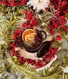 Sage & Stone Apothecary Winter Solstice Simmer Pot with citrus slices, herbs, and spices in a cozy ceramic pot.