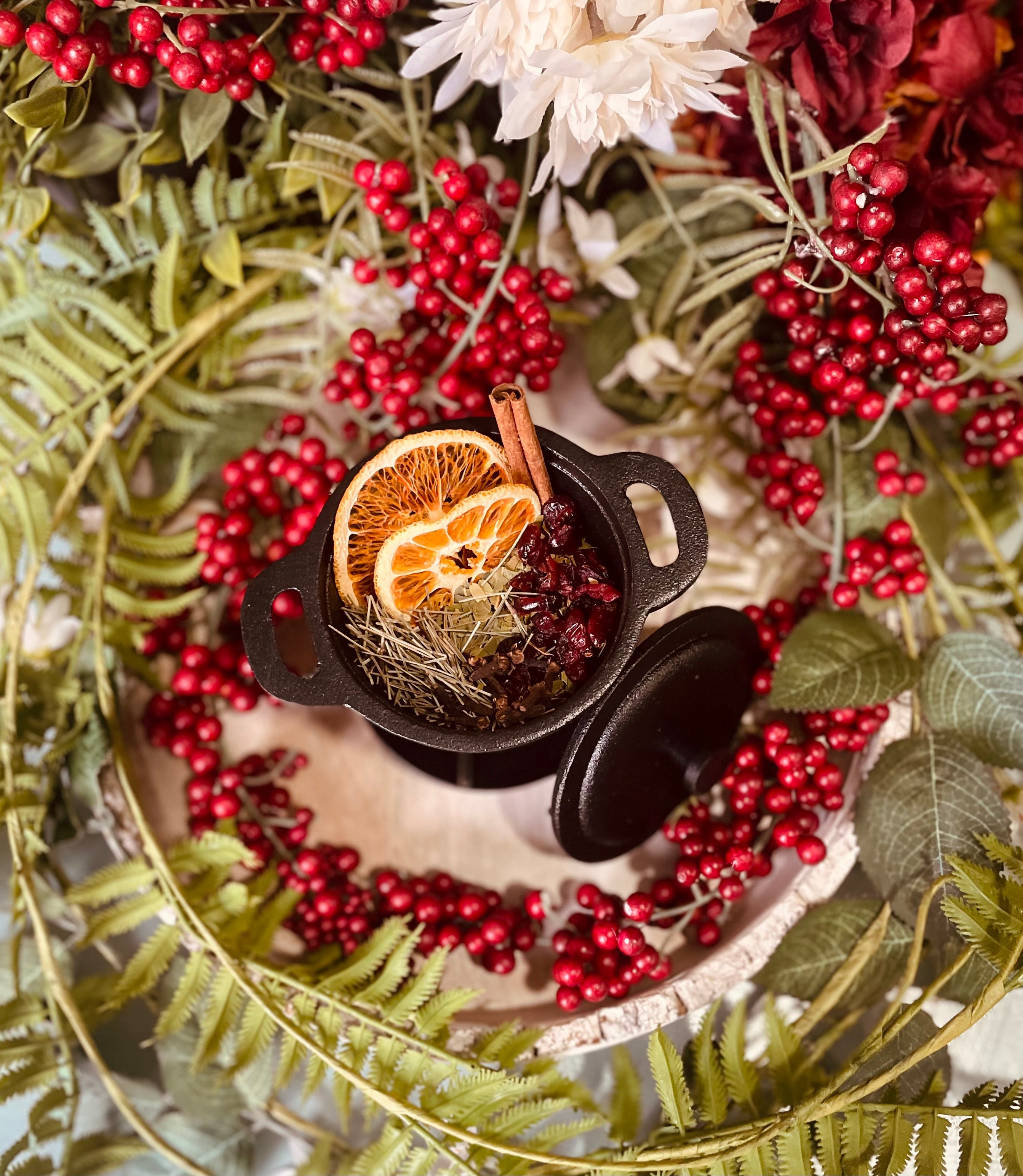 Sage & Stone Apothecary Winter Solstice Simmer Pot with citrus slices, herbs, and spices in a cozy ceramic pot.