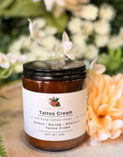 Sage & Stone Apothecary tattoo cream jar with label, creamy texture, and herbal ingredients for healing and moisturizing tattoos.