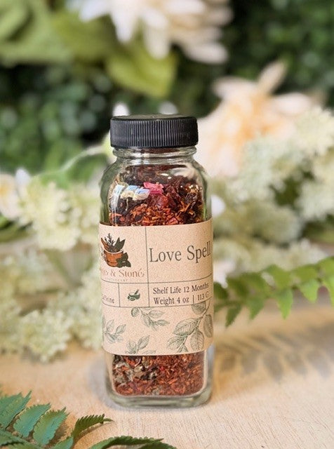 Sage & Stone Apothecary Love Spell herbal tea in a 4 oz package, featuring a colorful, botanical tea blend in a clear tea tin.