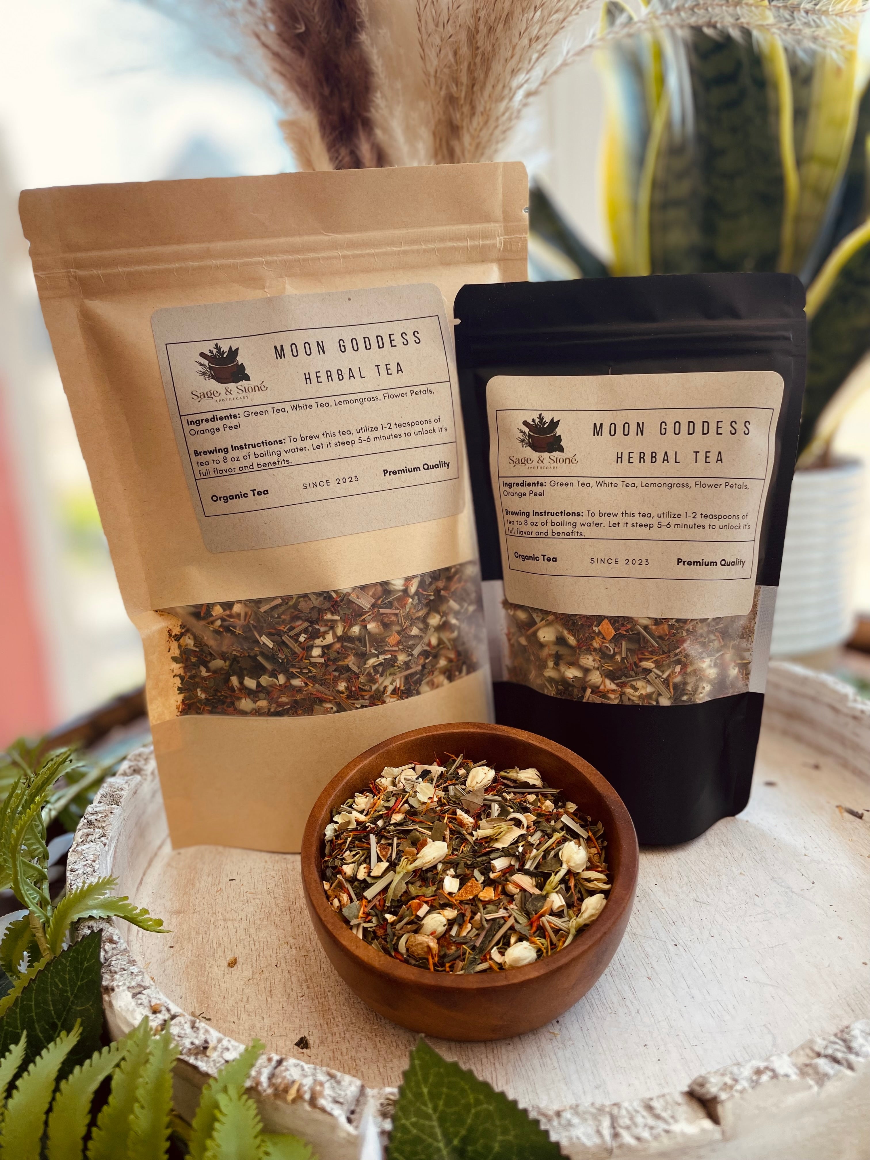 Moon Goddess Herbal Tea from Sage & Stone Apothecary, featuring a cozy cup of herbal tea with moon-themed packaging and dried herbs.