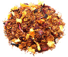 Sage & Stone Apothecary Cran-Orange Vanilla Tea in a glass teacup with orange slices and vanilla bean pods on a wooden table.