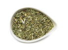 A cup of sage and stone apothecary gratitude tea with herbal tea leaves and a peaceful setting, showcasing the tea's calming qualities.