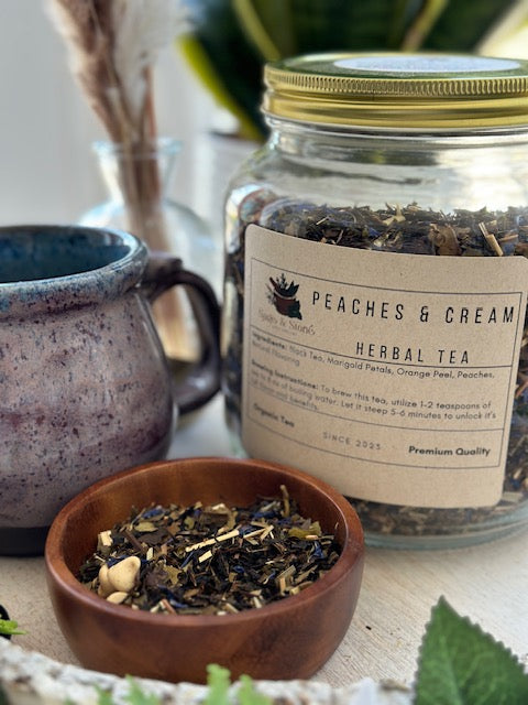 Cup of Peaches & Cream tea from Sage & Stone Apothecary showing a steaming tea brew in a ceramic mug.