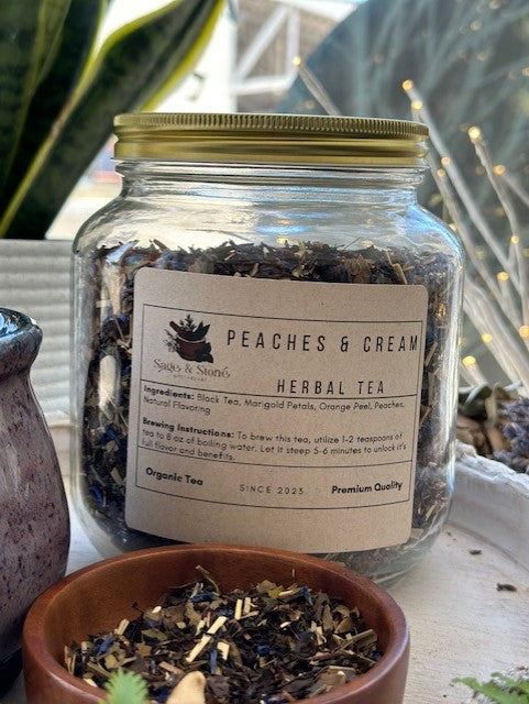 A cup of Peaches & Cream tea by Sage & Stone Apothecary with fresh peaches and creamy tea in a cozy setting.