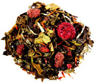 White raspberry and pomegranate tea by Sage & Stone Apothecary in a teacup with tea leaves and fresh fruit.