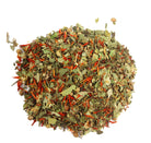 Sage & Stone Apothecary Watermelon Mint tea in a glass cup with fresh watermelon and mint leaves on a wooden table.