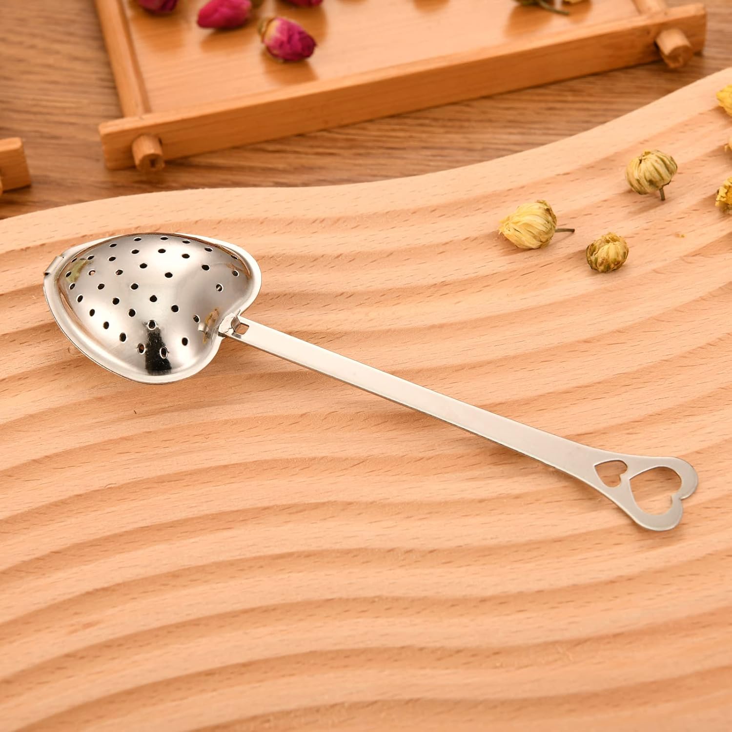 Heart-shaped tea infuser from Sage & Stone Apothecary, perfect for brewing loose leaf tea in a kitchen or as a gift.