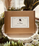 Assorted tea sampler set from Sage & Stone Apothecary featuring various tea and infusion blends in a gift-ready package.