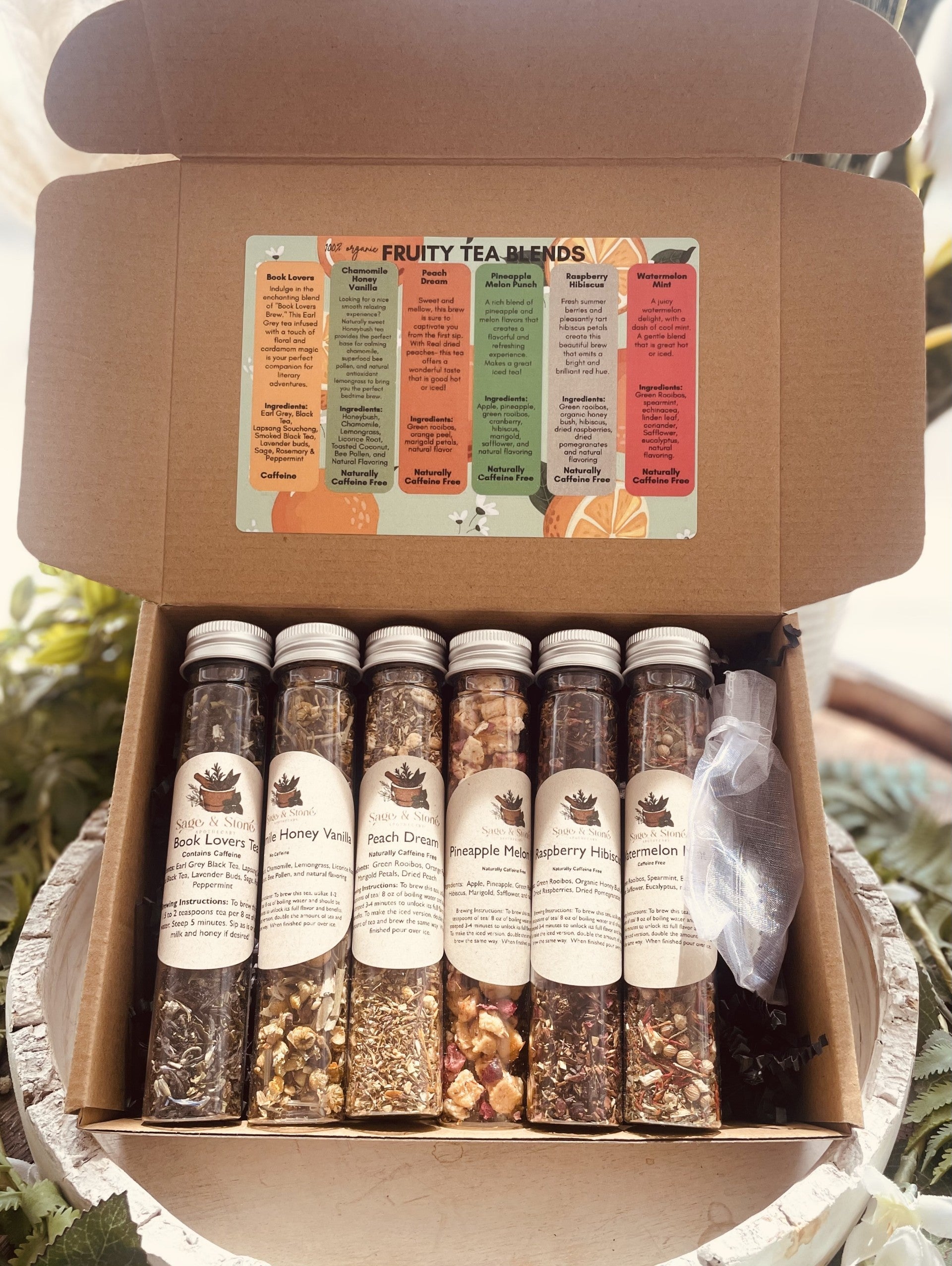Sage & Stone Apothecary Tea & Infusions sampler set with assorted fruity teas in small tins, perfect for gifting or kitchen use.