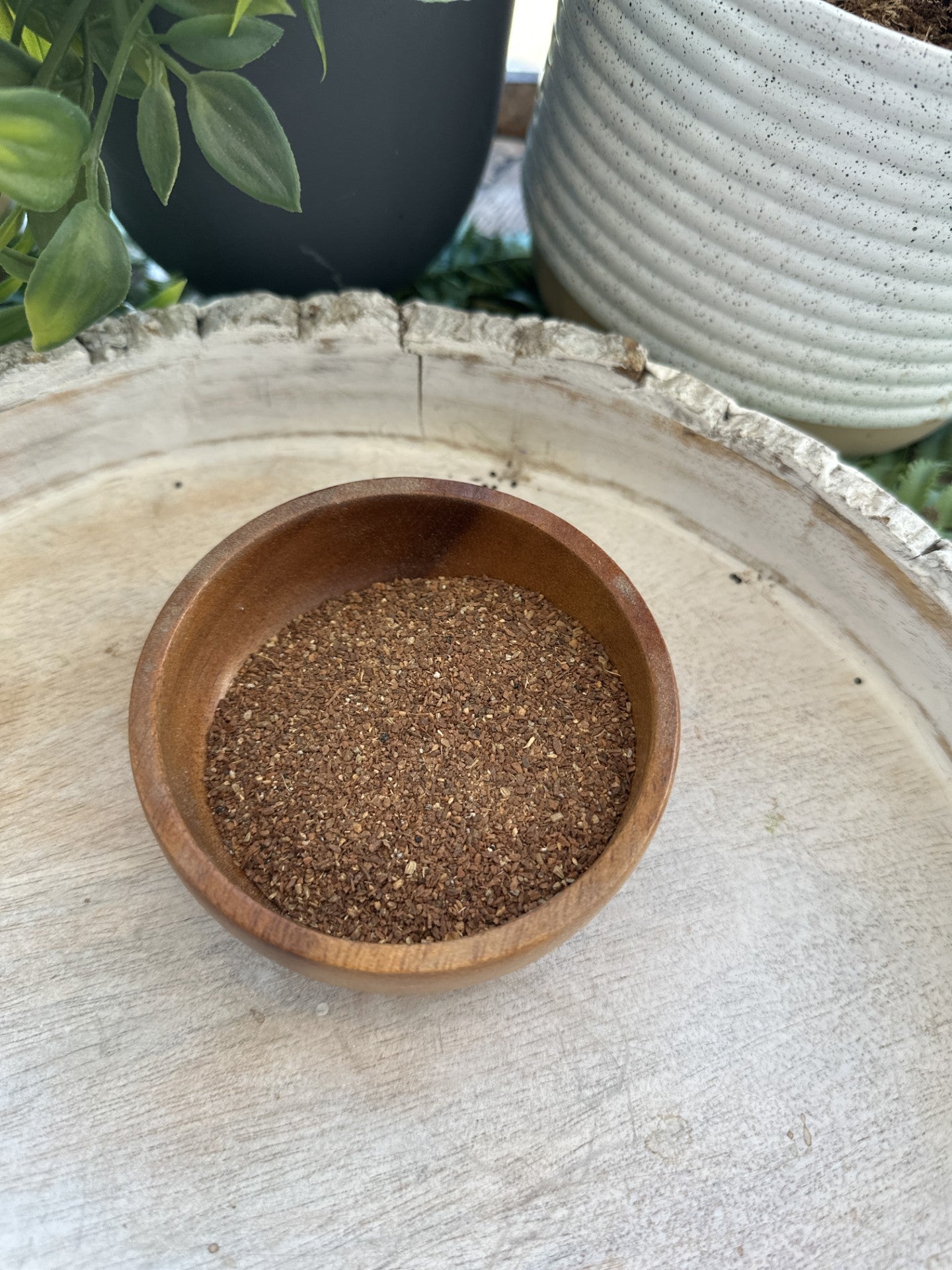 A steaming cup of chai tea from Sage & Stone Apothecary, showcasing a fragrant blend of spices and rich tea in a ceramic mug.