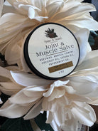 Sage & Stone Apothecary Joint & Muscle Salve in a jar, with herbal ingredients and a natural wellness focus.