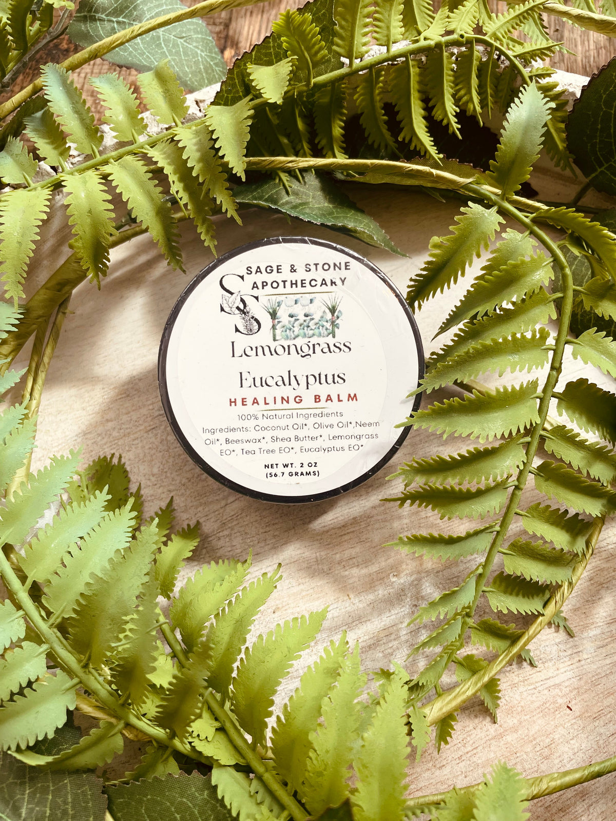 Lemongrass and eucalyptus healing balm in a jar from Sage & Stone Apothecary, with natural ingredients and herbal packaging.