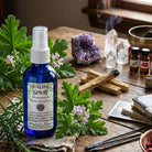 Shamans Dawn Healing Spray bottle with a spray nozzle, featuring a natural herbal label on a wooden surface.