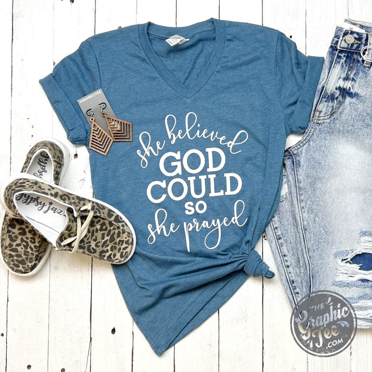 Women’s V-neck graphic tee featuring the quote "She Believed God Could So She Prayed" by The Graphic Tee.