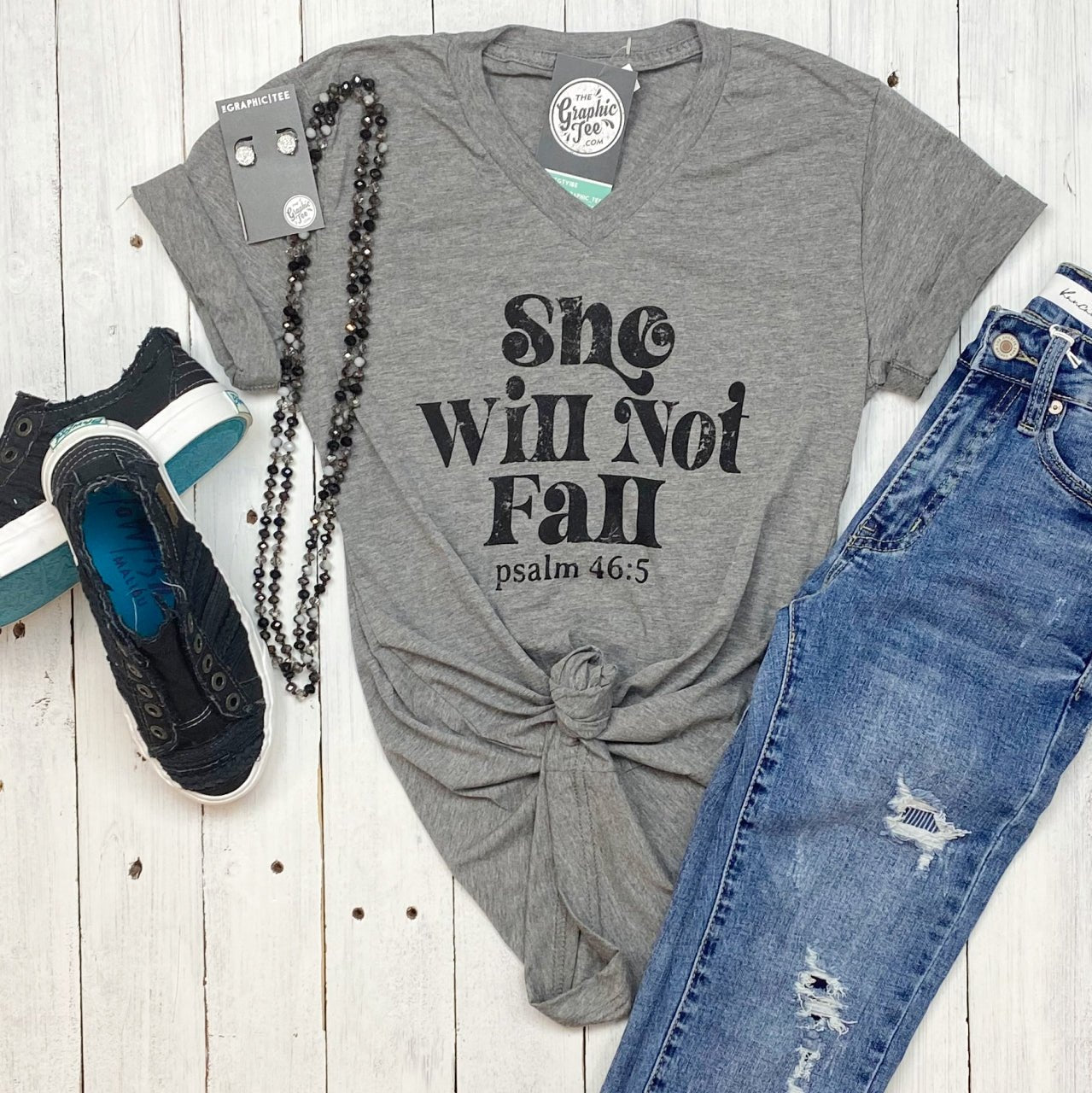 Women’s She Will Not Fall V-Neck Graphic T-Shirt by The Graphic Tee, featuring empowering design and comfortable fit.