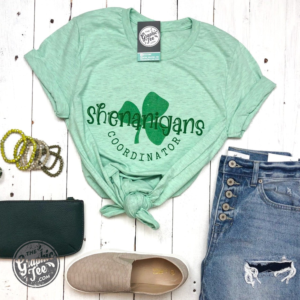 Shenanigans Coordinator Prism Mint crew neck graphic t-shirt by The Graphic Tee, featuring a colorful, eye-catching design on soft cotton.