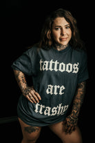 Tattoos Are Trashy graphic T-shirt by Shop Karma Tees featuring bold black text on a white cotton tee.