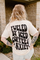 Graphic tee featuring "Fueled by iced coffee and anxiety" design on a casual unisex shirt from Shop Karma Tees.