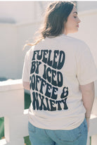 Graphic tee featuring "Fueled by Iced Coffee and Anxiety" by Shop Karma Tees, showcasing a casual, stylish design on soft fabric.