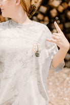 Black graphic tee featuring "Fueled by iced coffee and anxiety" slogan from Shop Karma Tees, casual wear with bold text design.
