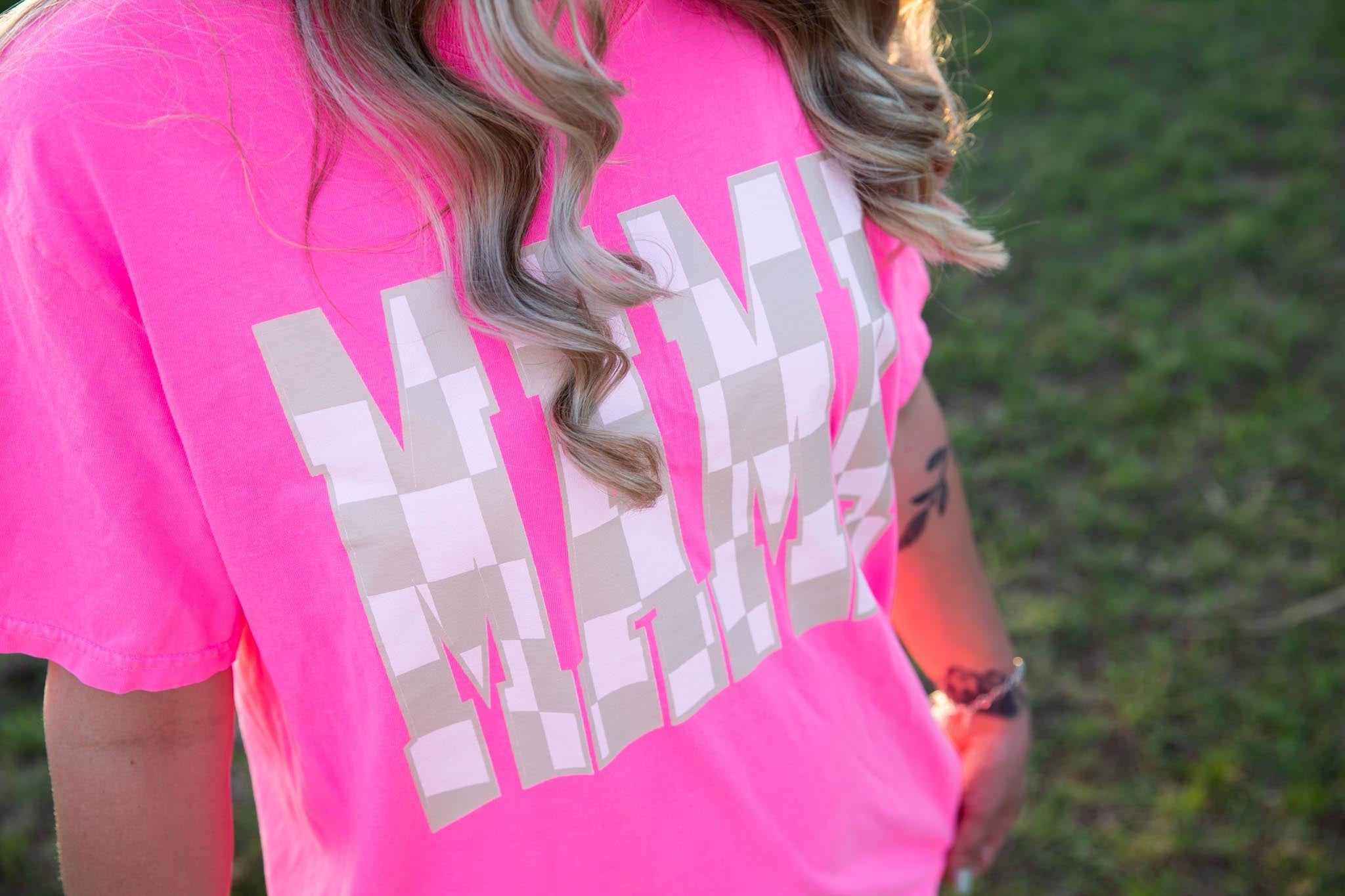 Mama checkered graphic T-shirt from Shop Karma Tees featuring a bold checkered design on soft cotton fabric.