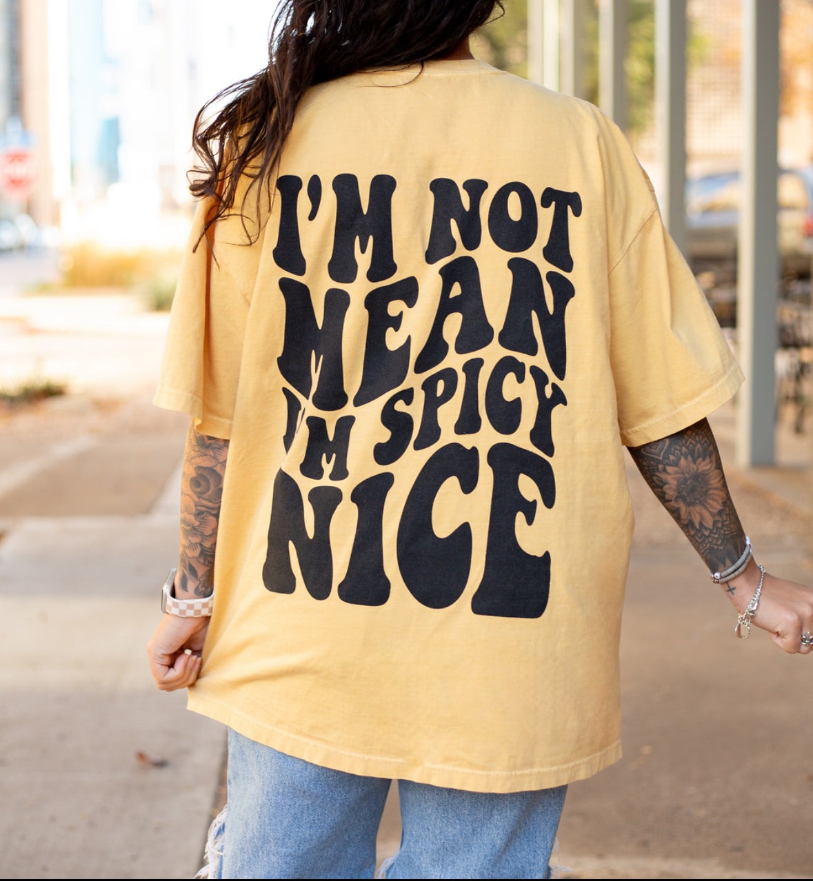 I'm Spicy Nice graphic t-shirt by Shop Karma Tees, featuring bold, colorful "I'm Spicy Nice" text on a casual cotton tee.