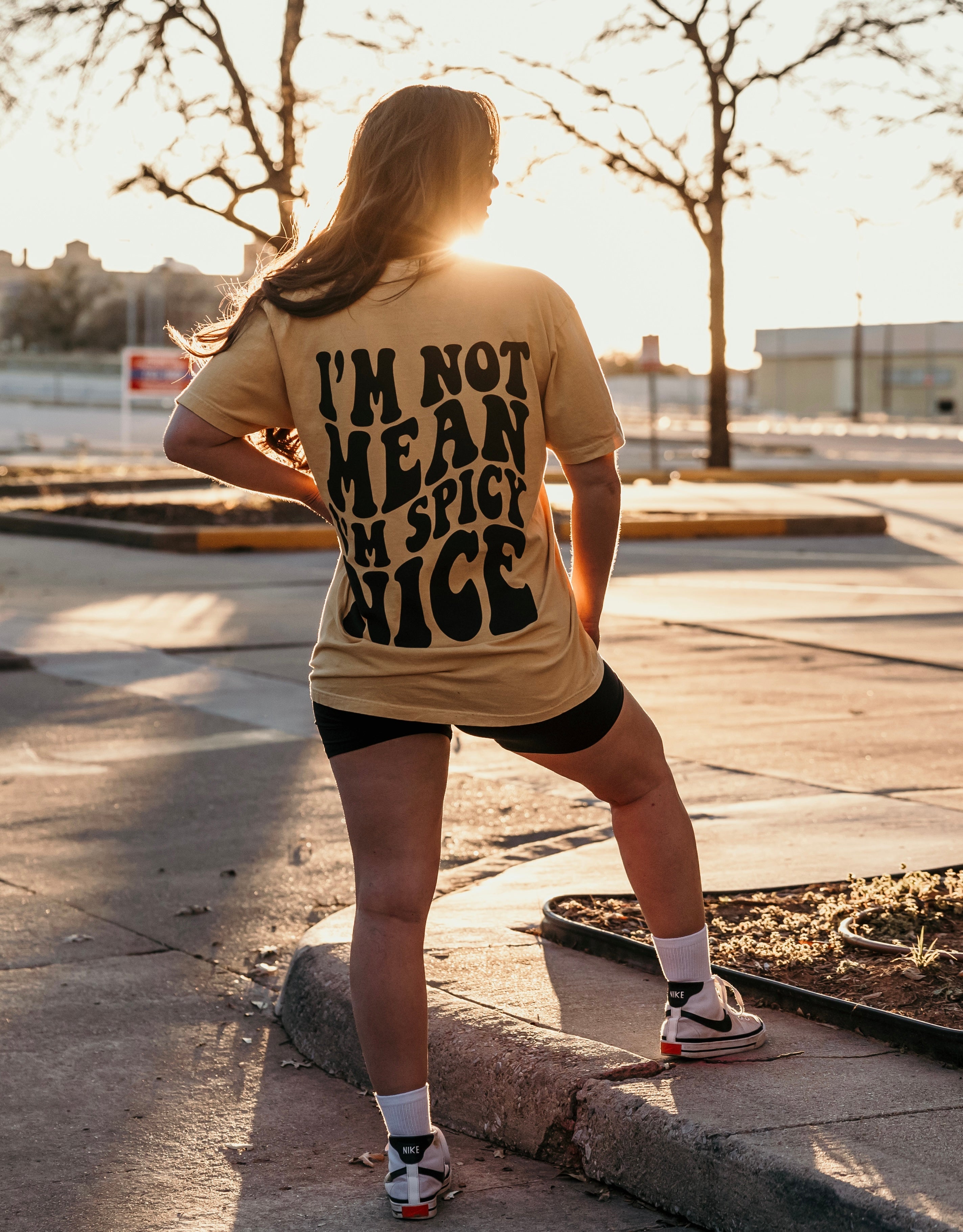 I'm Spicy Nice graphic T-shirt from Shop Karma Tees featuring bold lettering and vibrant spring-themed colors.