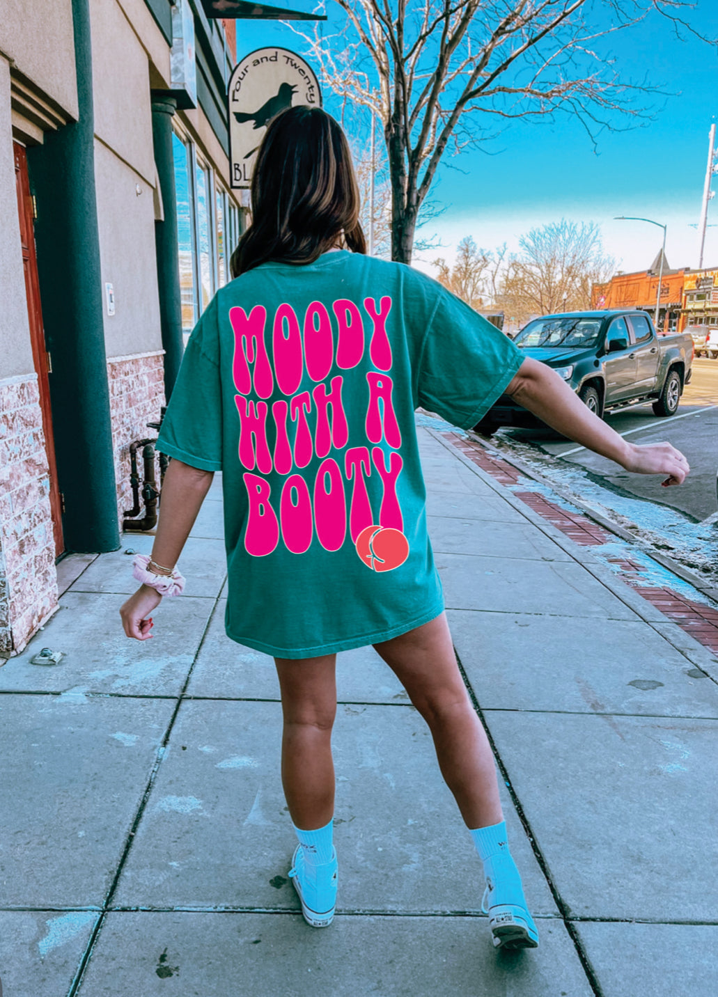 Moody with a Booty graphic T-shirt from Shop Karma Tees featuring a bold, colorful design on soft cotton fabric.