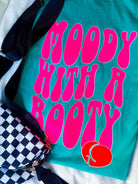Black graphic t-shirt from Shop Karma Tees featuring the Moody with a Booty design, casual fit with bold print.
