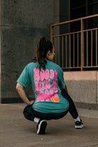 Moody with a booty graphic t-shirt by Shop Karma Tees, featuring bold print and casual fit on a white cotton tee.